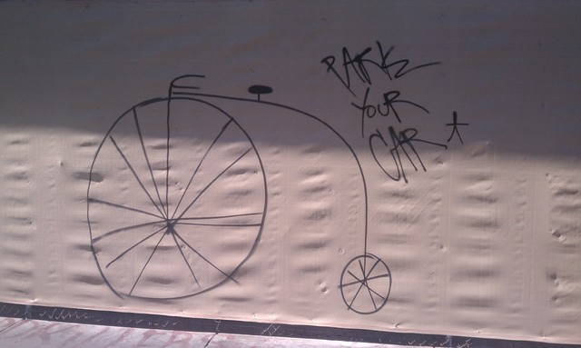 Downtown street art offers a penny farthing for your thoughts